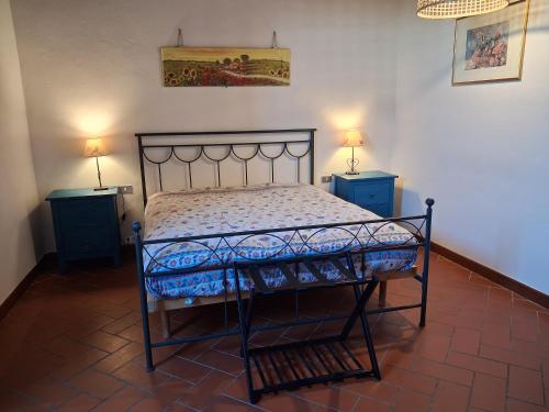 a bed in a room with two night stands and two lamps at Canto dei Merli in Greve in Chianti