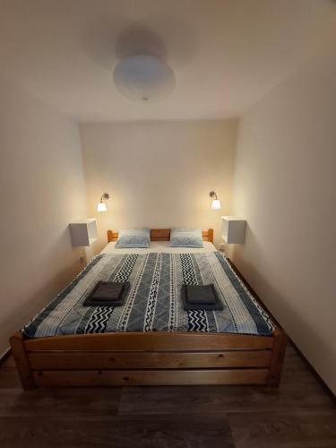 a large bed in a room with two lamps on it at Apartmány pod Divadlem in Znojmo