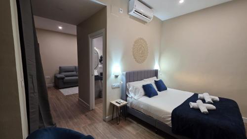 a bedroom with a bed with two teddy bears on it at Casona de San Andrés Boutique Hotel in Seville