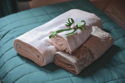 two towels sitting on top of a bed at La Casa Nel Corso in Pitigliano