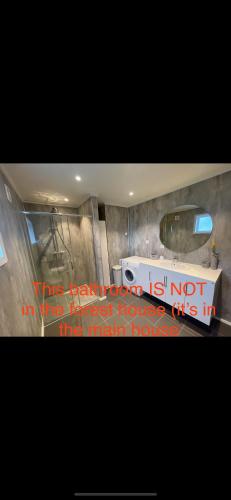 a bathroom with a sign that says the bathroom is not in the most house at Forest Hideaway With Scenic View in Fiskå