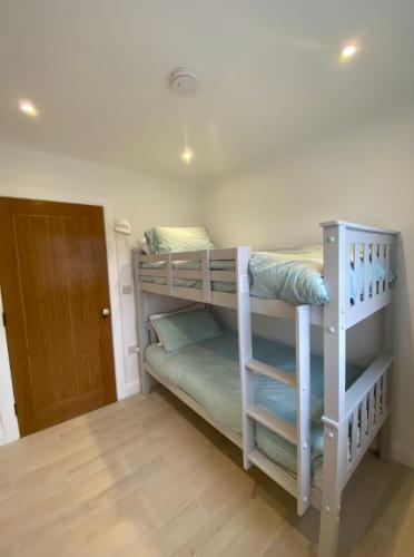 two bunk beds in a room with a door at Lakeview in Keel