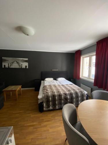 a bedroom with a bed and a table and chairs at Pensionat Björnen in Östersund