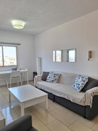 a living room with a couch and a table at Delphi Court - large 1 bed -sleeps 4, Near sea/beach - free wifi in Limassol