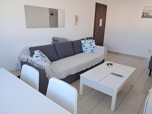 a living room with a couch and a table at Delphi Court - large 1 bed -sleeps 4, Near sea/beach - free wifi in Limassol