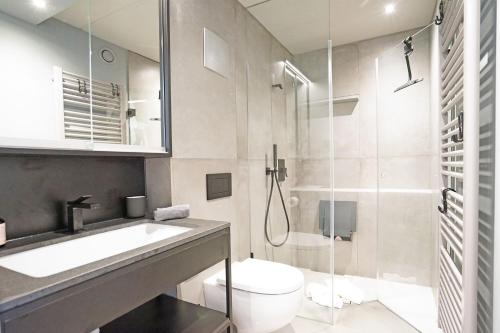 a bathroom with a toilet and a sink and a shower at Exclusive Maisonettewohnung! in Nesselwang