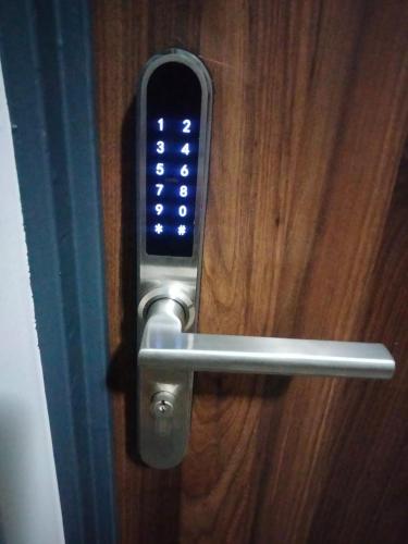 a cell phone sticking out of a door handle at Apartament SIEDEMNAŚCIE in Sanok