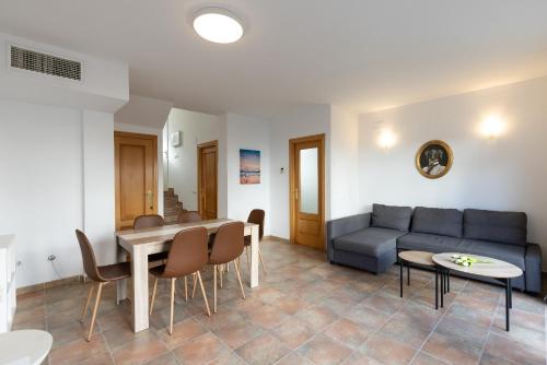 a living room with a couch and a table and chairs at Cumbre in Salou