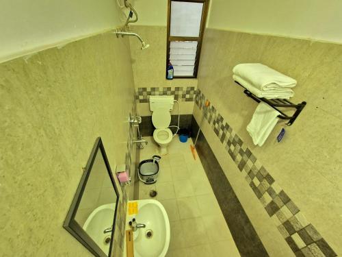 a bathroom with a shower and a toilet and a sink at Luxe Haven Homestay 2A in Guwahati