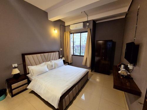 a bedroom with a large bed and a window at Luxe Haven Homestay 2A in Guwahati