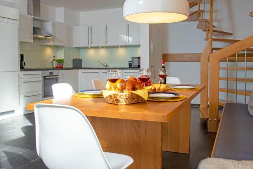 a kitchen with a wooden table with a basket of food at Chalet am Breitenberg Apt1 in Pfronten