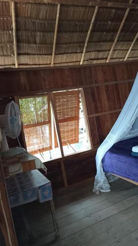 a room with a bed and two windows at Homestay Tapor Aikos in Besir