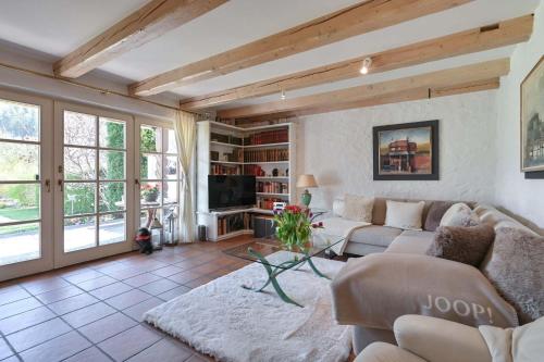 a living room with a couch and a tv at Haus Bella in Schwangau