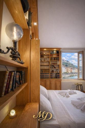 a bedroom with a bed and a window and bookshelves at MYD - The Jules Verne in Grenoble