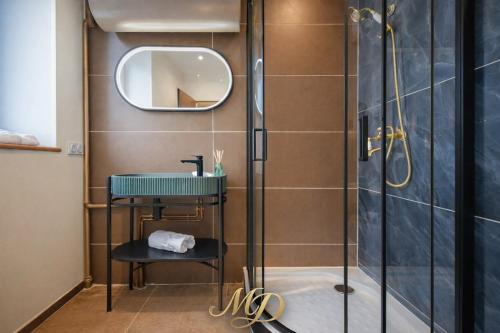 a bathroom with a shower and a sink and a mirror at MYD - The Jules Verne in Grenoble