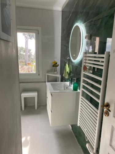 a bathroom with a white sink and a mirror at FRAROCKA B and B in La Ciotat