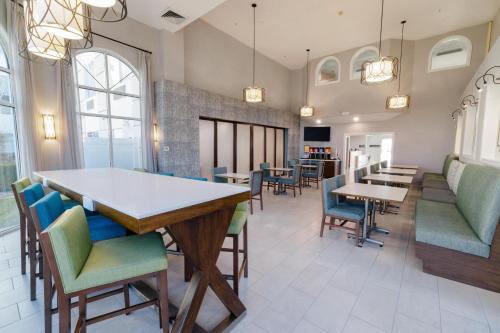 a dining room with a table and chairs at Hampton Inn & Suites Salt Lake City Airport in Salt Lake City