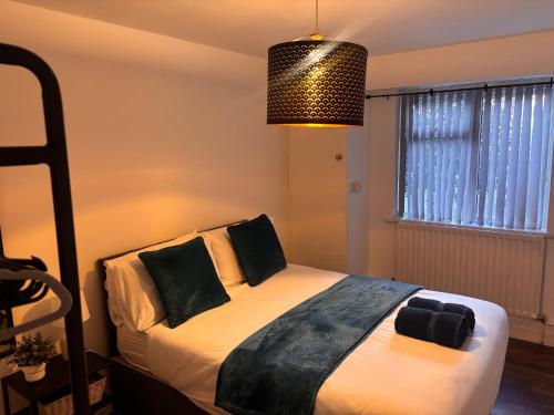 a bedroom with a bed and a pendant light at Spacious 3-bed apartment close to Birmingham City with free parking with Netflix contractor stays welcome in Birmingham