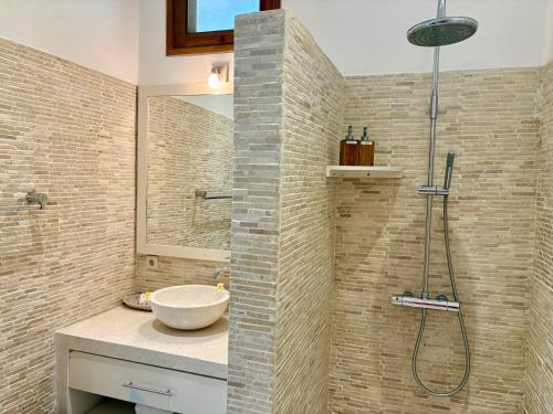 a bathroom with a sink and a shower at Villa Nirwana in Lovina