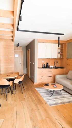 a living room with two tables and a couch at Apartment Vučko Lux C334 Private host in Jahorina