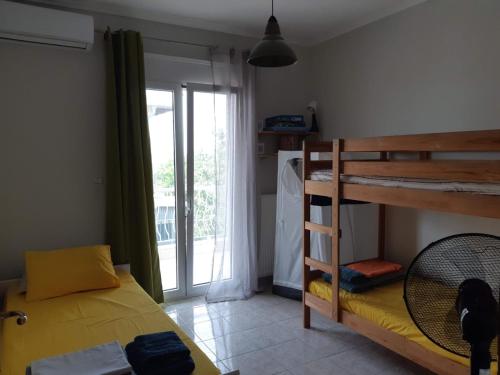 a bedroom with a bunk bed next to a balcony at Villa Belvedere Flogita in Flogita
