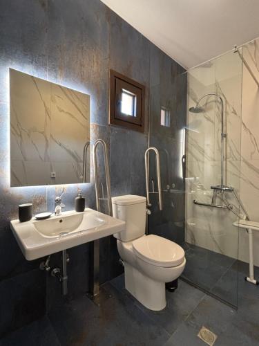 a bathroom with a toilet and a sink and a shower at Agios Nikolaos Open Living Suite in Agios Nikolaos