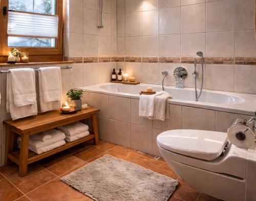 a bathroom with a tub and a toilet and a sink at Laax Cozy Apartment - Ski Bus - Fireplace in Laax