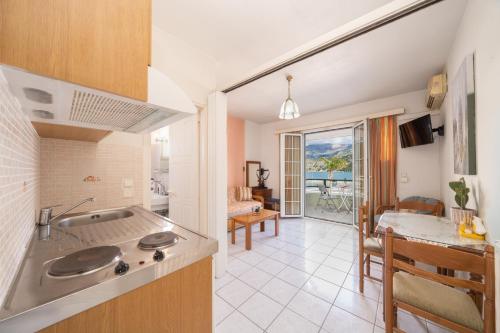 a kitchen and dining room with a view of the ocean at Myros Studios in Argostoli