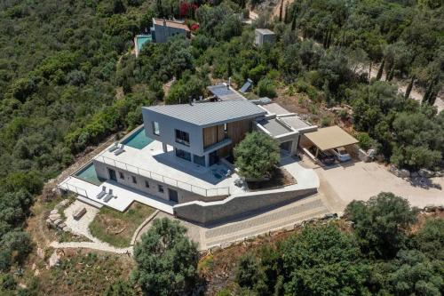 an aerial view of a house with a pool at VILLA ODISSOS - Private Paradise with 2 infinity pools & Sea access in Sivota
