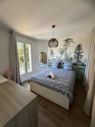 a bedroom with a bed with a stuffed animal on it at Elégance du Golfe in Vallauris