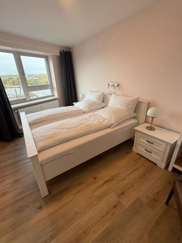 a bedroom with a large bed with a window at Palaceblick in Schleswig