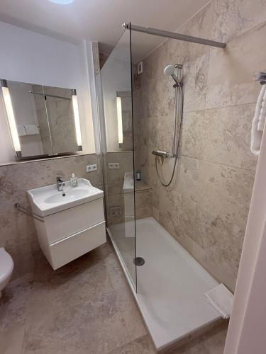 a bathroom with a shower and a sink at Palaceblick in Schleswig