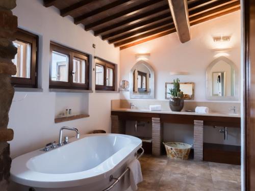 a bathroom with a large tub and two sinks at Vogue Hotel Arezzo in Arezzo