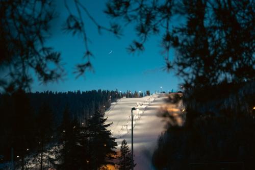 a snowy road with street lights in the snow at Break Sokos Hotel Tahko in Tahkovuori