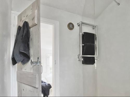 a bathroom with a door and a towel rack at Shrimp Cromer in Norwich