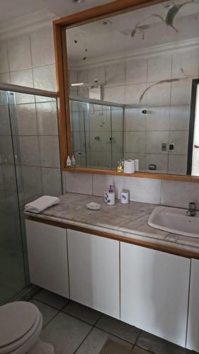 a bathroom with a sink and a mirror at Casa Meão in Recife