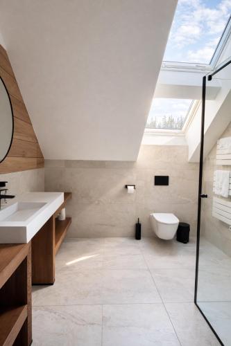 a bathroom with a sink and a toilet at Ski and Bike Residence in Istebna
