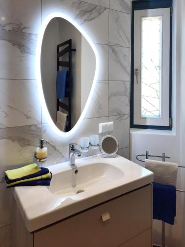 a bathroom with a sink and a mirror at Seevilla Nina in Maria Wörth
