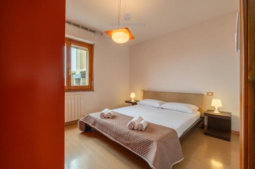 a bedroom with a bed and two towels on a table at Domo Mea-House Live Express in Quartu Sant'Elena