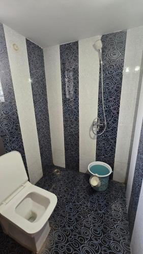 a bathroom with a toilet and a shower at I Rose Guest House By Olive in Talaulim