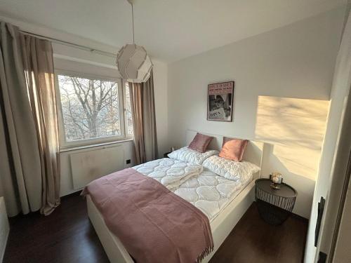 a bedroom with a large bed and a window at Faraway Homes Studio Bruck #11 in Bruck an der Mur