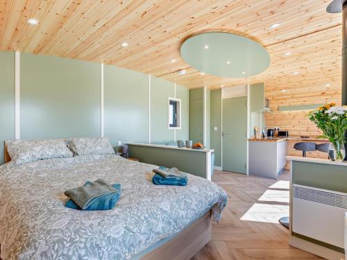 a bedroom with a large bed with a wooden ceiling at 1 Bed in Matlock oc-96256 in Crich