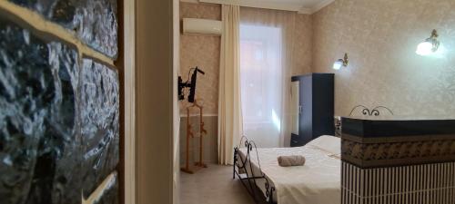 a small room with a bed in a room at Hidden Rooms Freedom Square in Tbilisi City