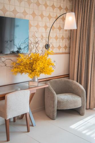 a room with a desk and a chair and a lamp at Wine & Books by the Sea, Algarve Resort in Albufeira