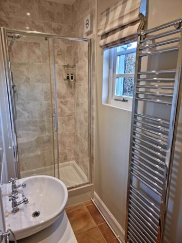 a bathroom with a shower and a sink at Huntshaw Stables in Earlston