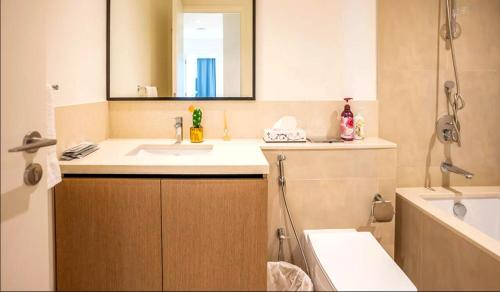 a bathroom with a sink and a mirror and a tub at Prime Luxury Private Room in Downtown near Burj Khalifa in Dubai