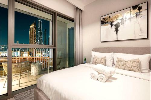 a bedroom with a bed and a large window at Prime Luxury Private Room in Downtown near Burj Khalifa in Dubai