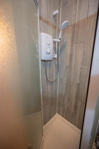 a shower with a shower head in a bathroom at The Pheasant in Broseley