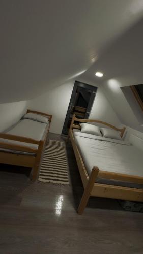 two bunk beds in a room with a roof at Cabana Trofelor in Comandău