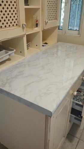 a kitchen with a white marble counter top at Casa mar in Las Galeras